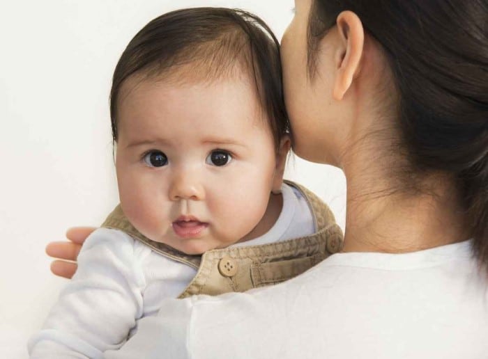 Mother burping her baby