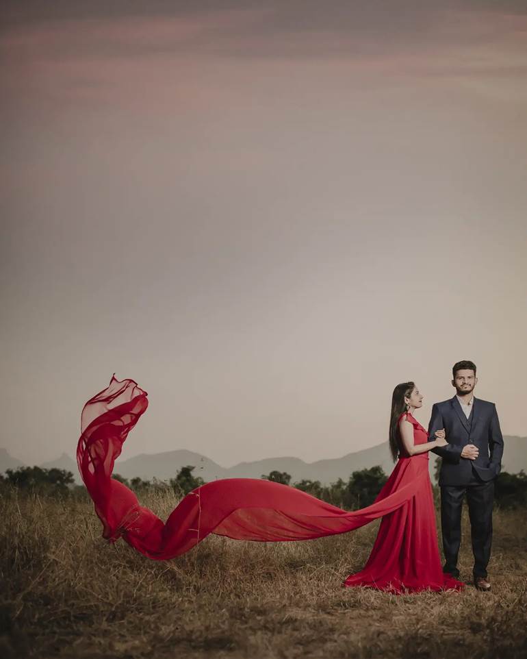 Pré wedding com vestido vermelho esvoaçante no campo